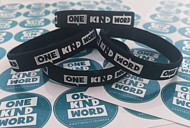 One Kind Word wristbands and stickers