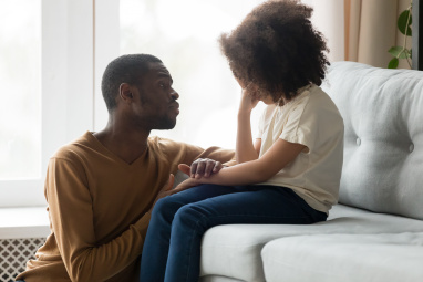 Dad talking to his child who looks upset