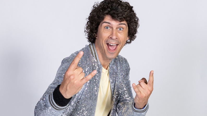 Andy Day, from Andy and the Odd Socks, standing with a smile