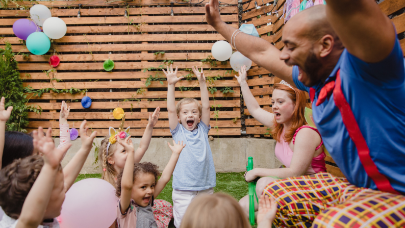 young people celebrating in a group with an adult