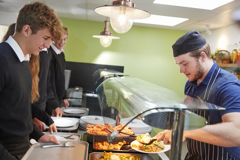 Secondary school child getting their lunch in school